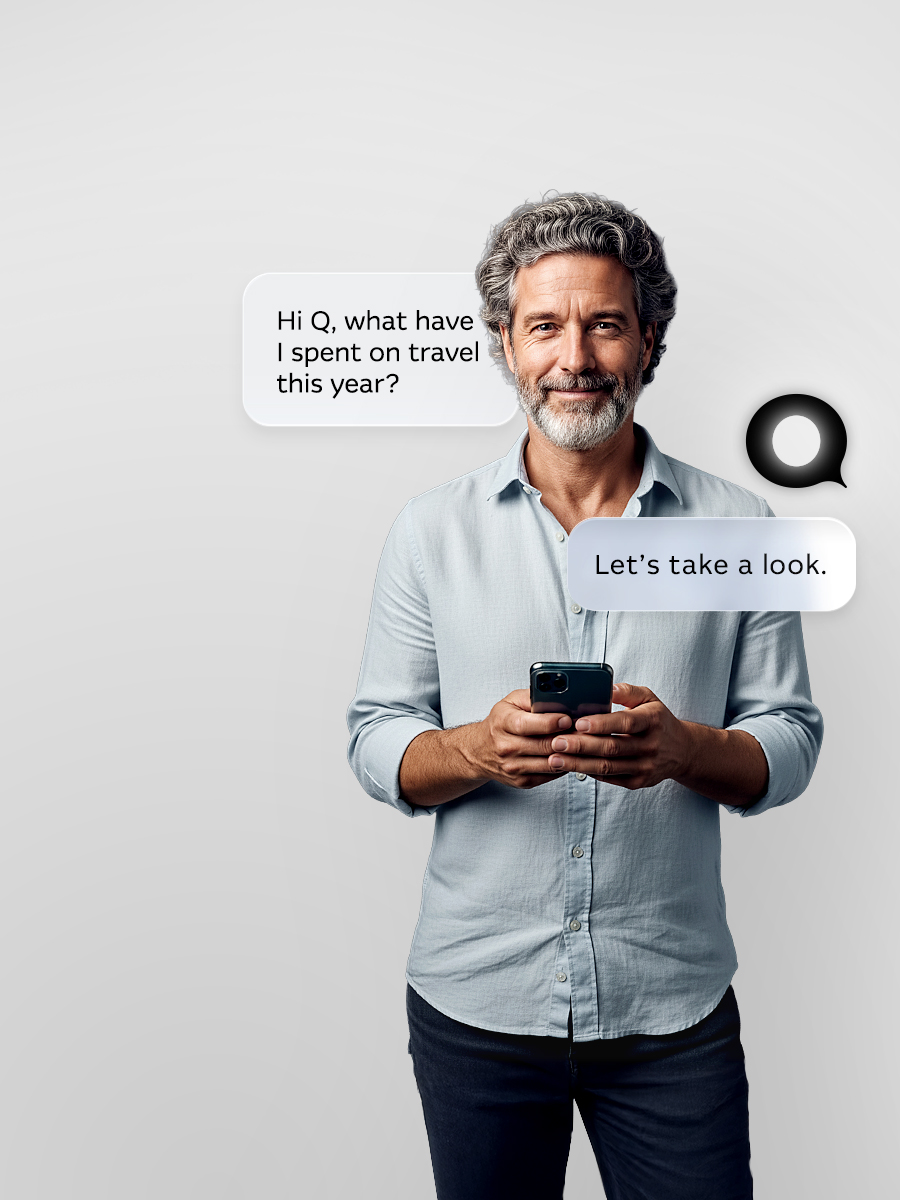 Man dressed casually smiling at camera, standing with hands in pockets