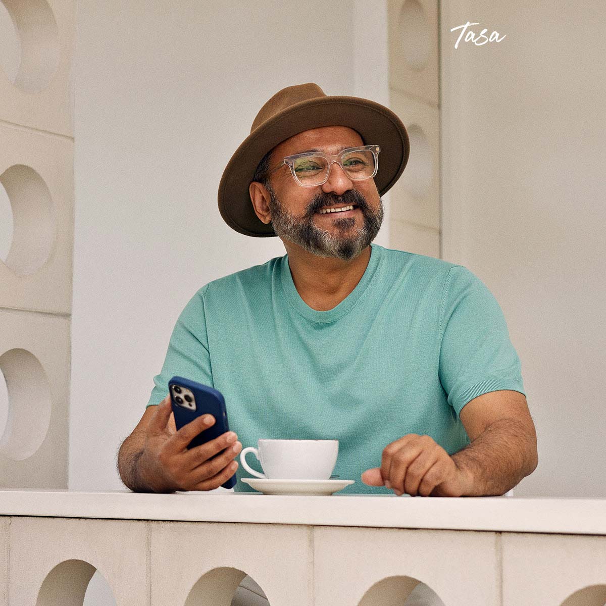 tasa-smiling-holding-phone