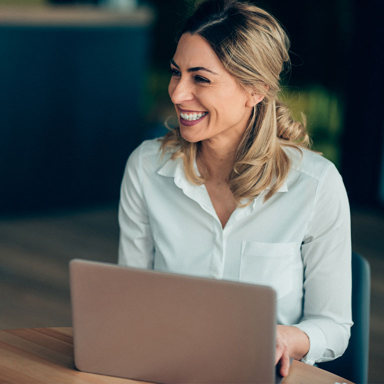 Smiling Business woman working at a cafe at a round table