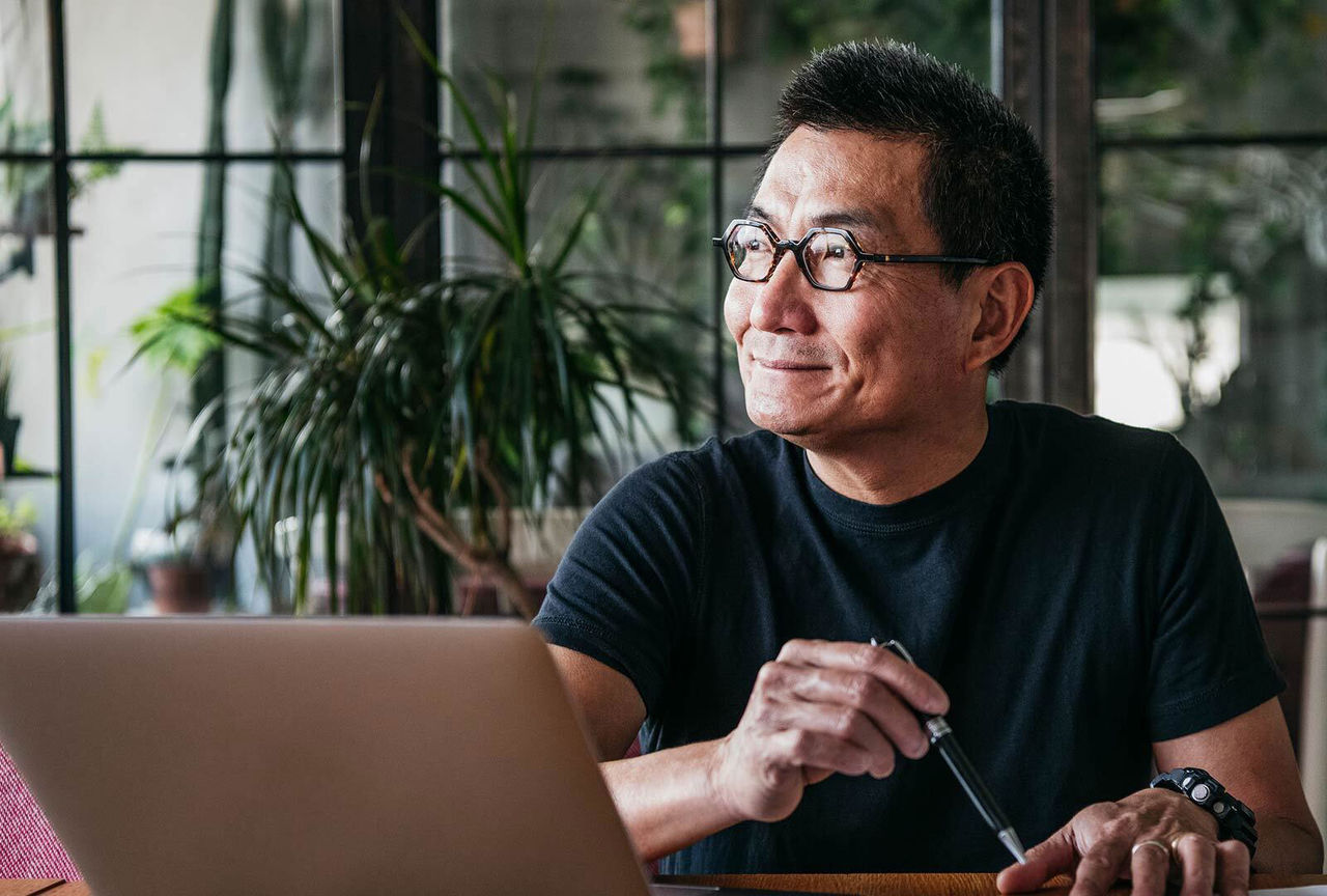 Mature man using laptop at home