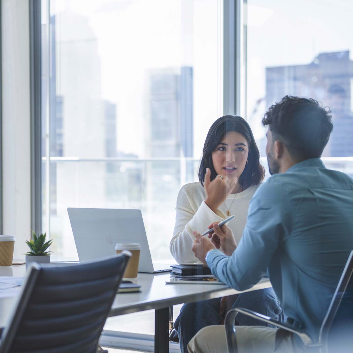 man and woman having a discussion in an office