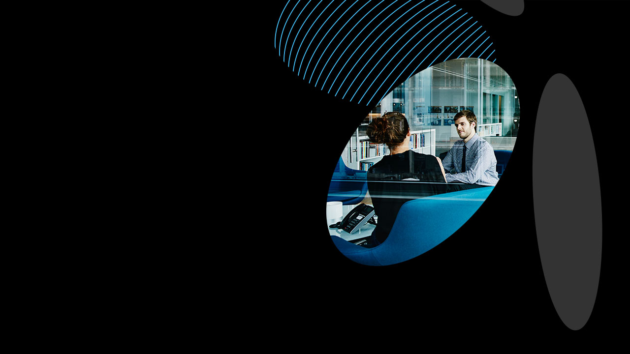 Businessman and businesswoman discussing project in office conference room