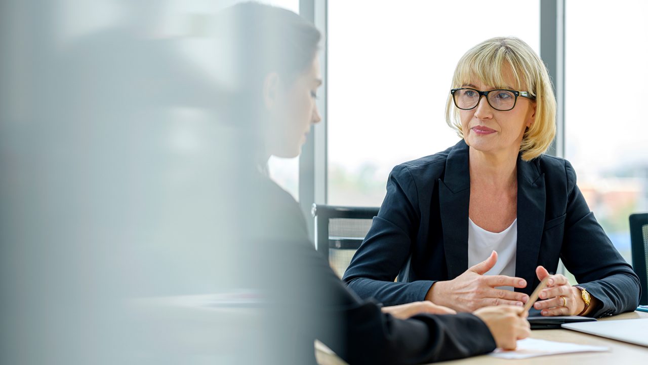 Serious female advisor and client talking