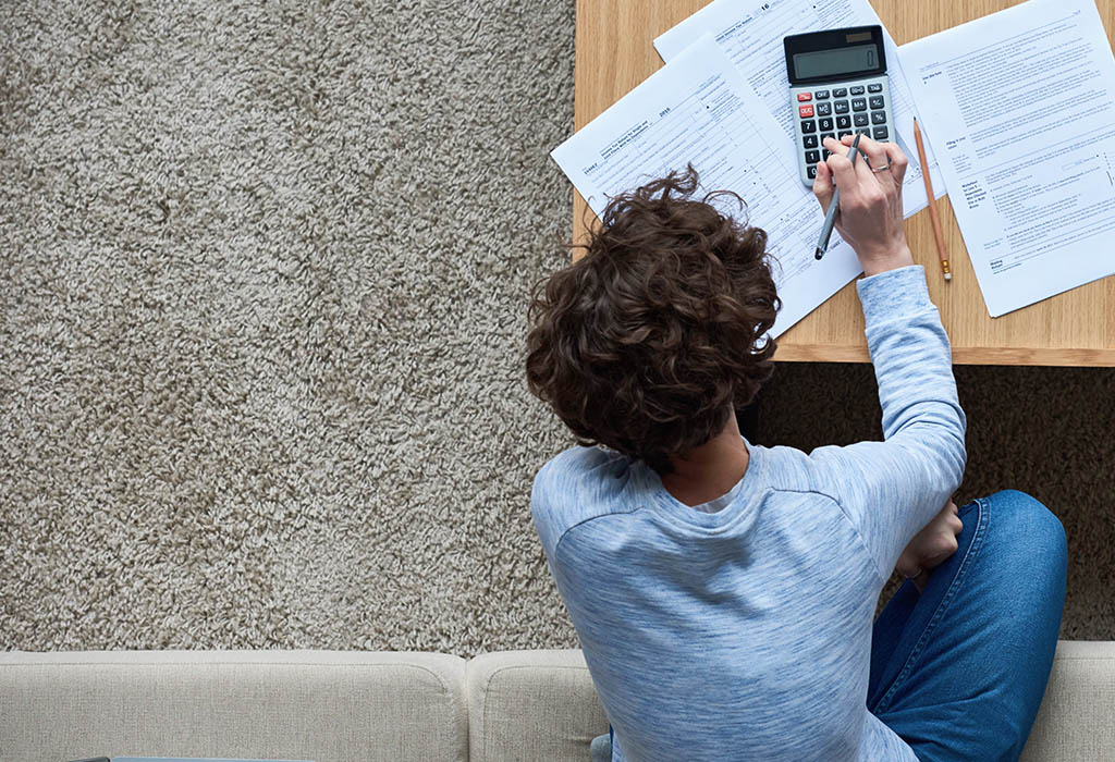 Working out a savings plan with a calculator at a desk