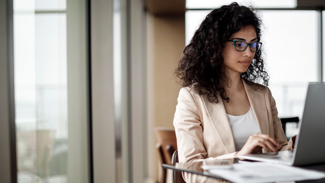 Businesswoman working on laptop in a coffee shop