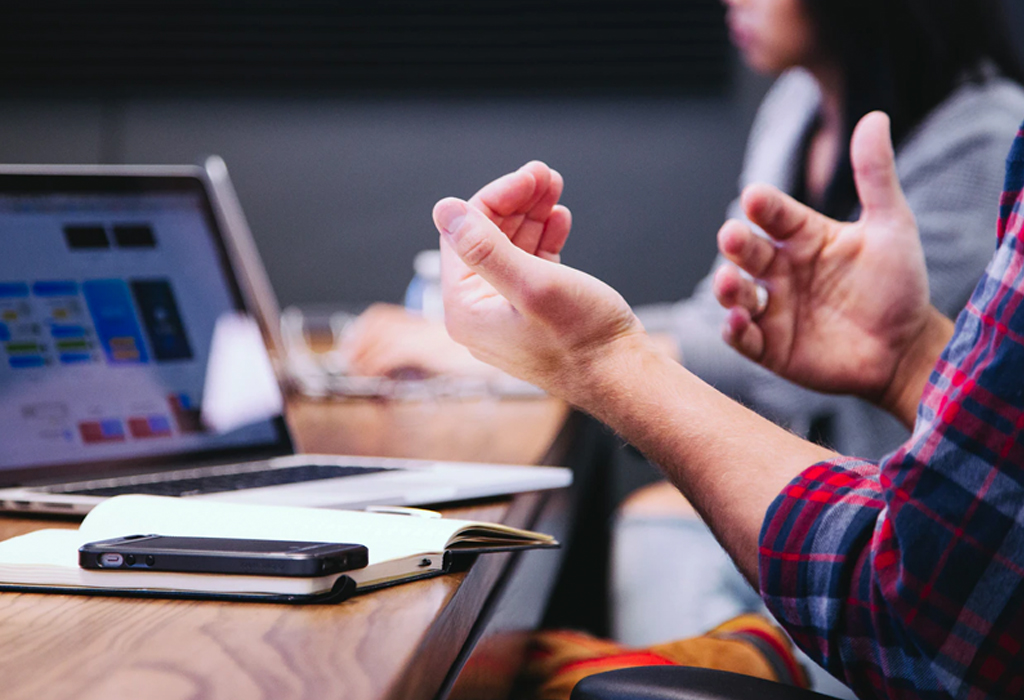 expressive hands in meeting discussion.