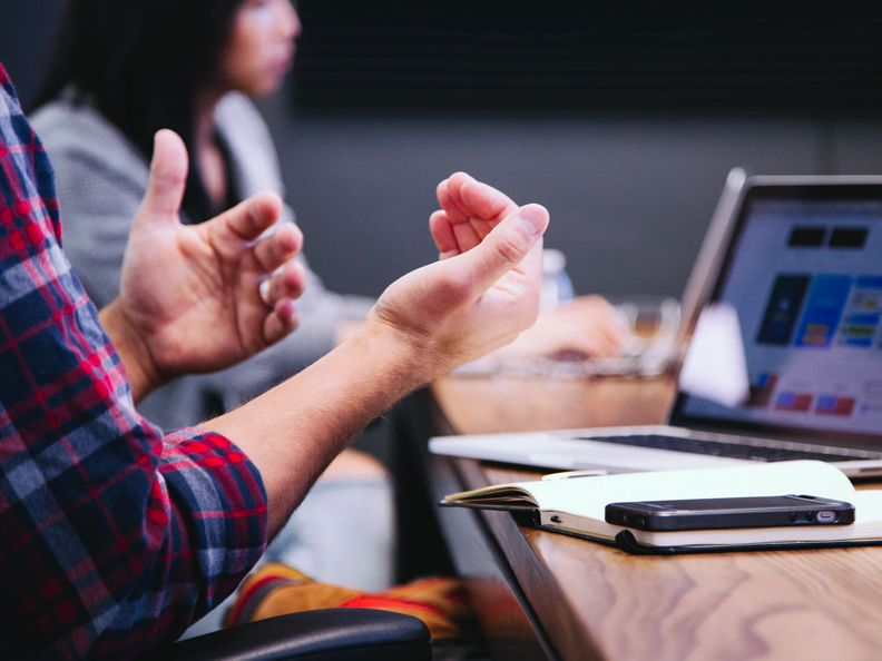 expressive hands in meeting discussion.