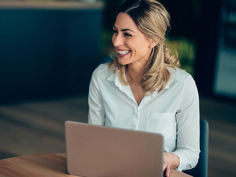 Smiling Business woman working at a cafe at a round table