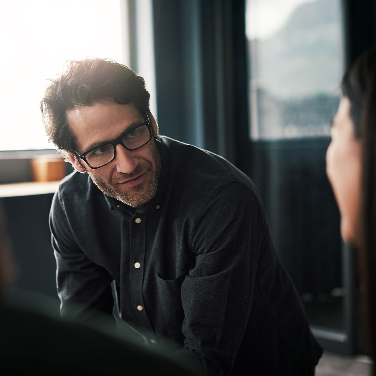 Shot of a mature businessman discussing ideas with his colleagues during a meeting at work