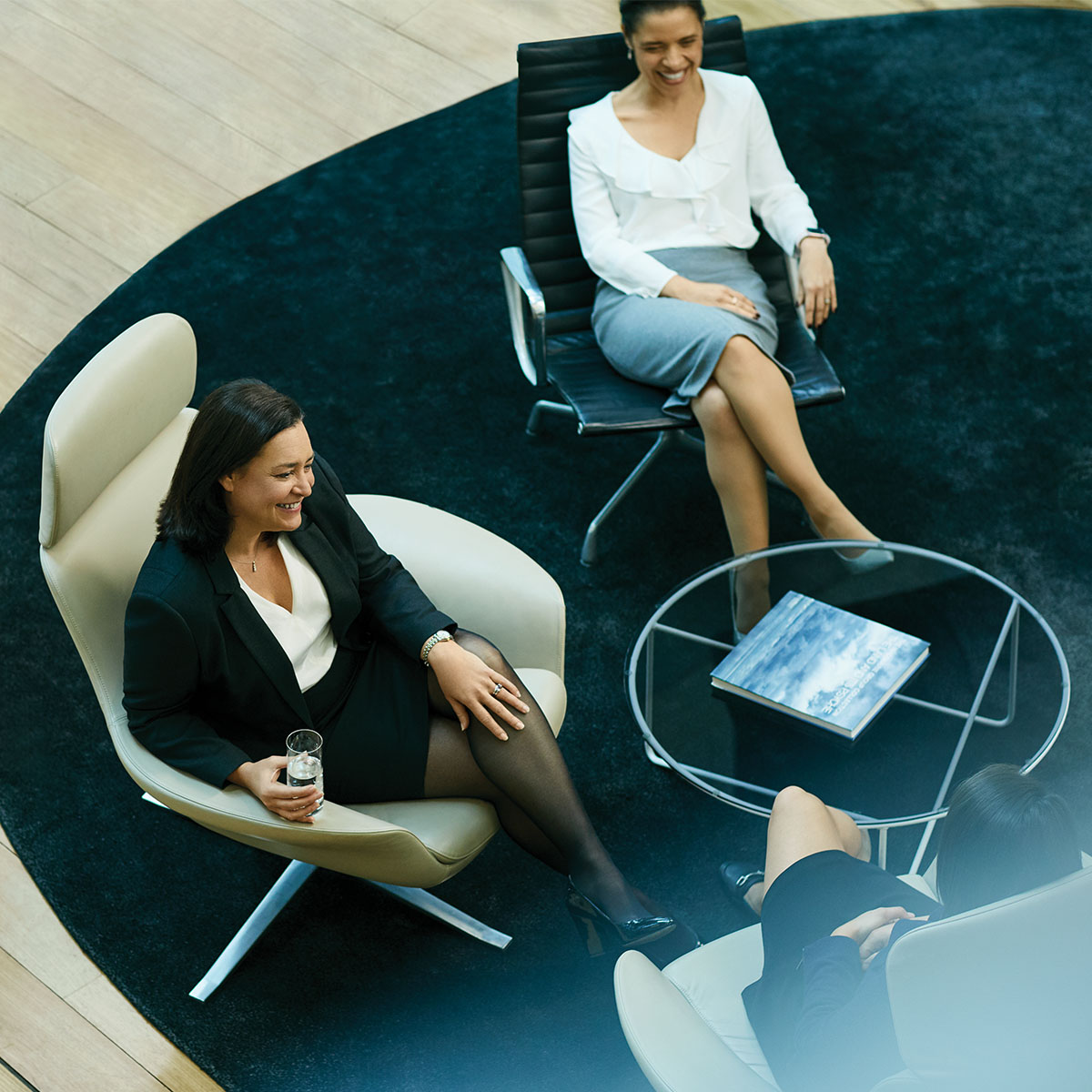A high angle shot of two professional women in a Macuqarie office lobby