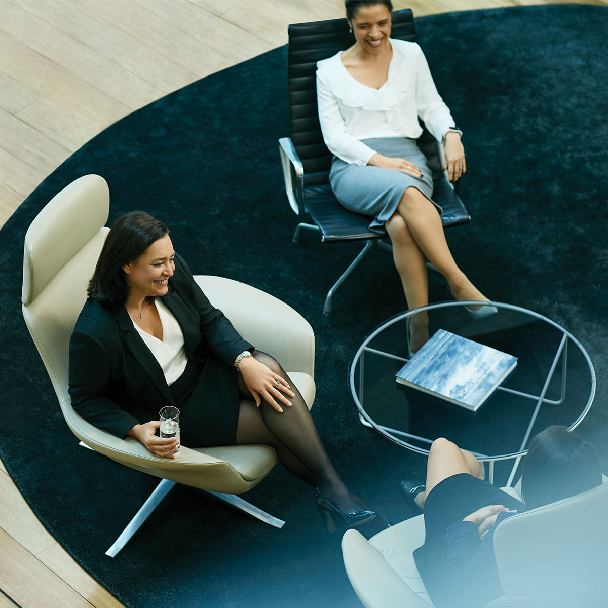 A high angle shot of two professional women in a Macuqarie office lobby