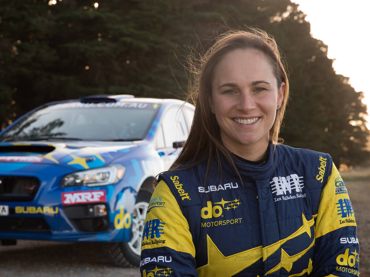  Molly Taylor standing in front of race car