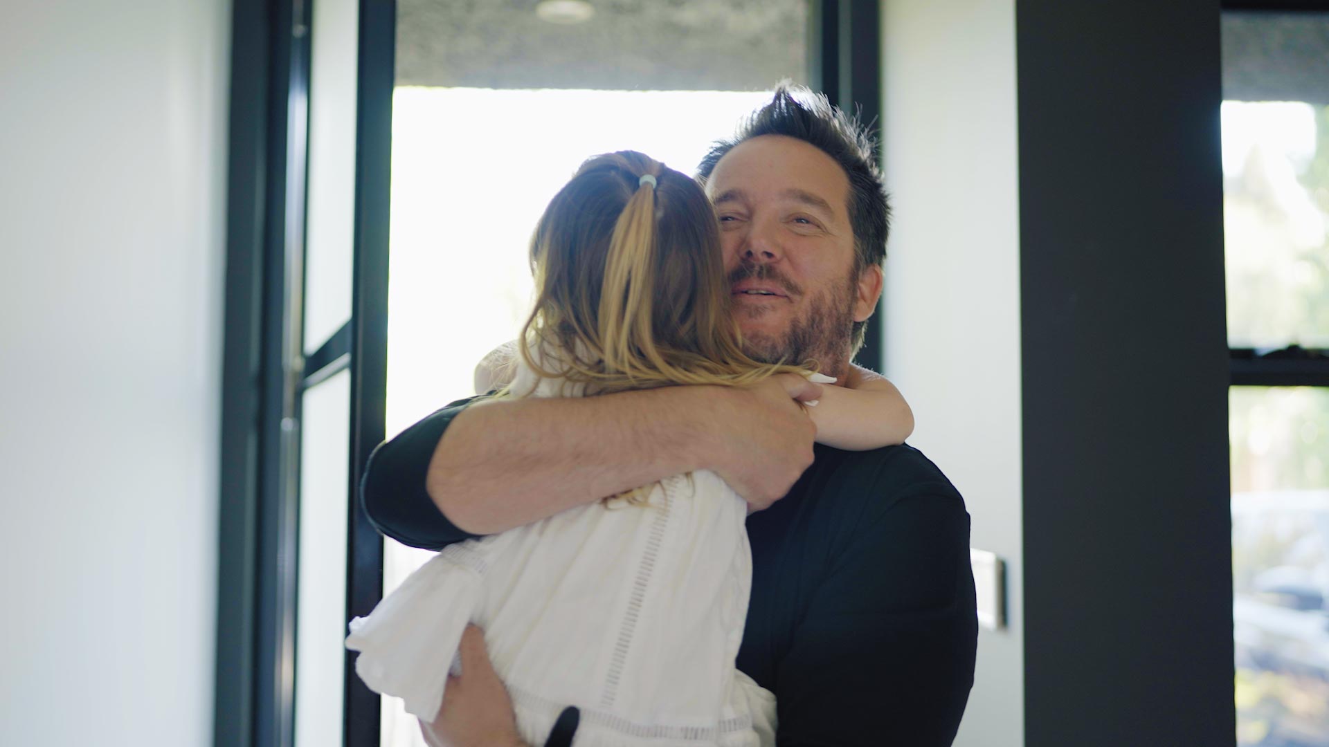 Chris Riddell hugging daughter