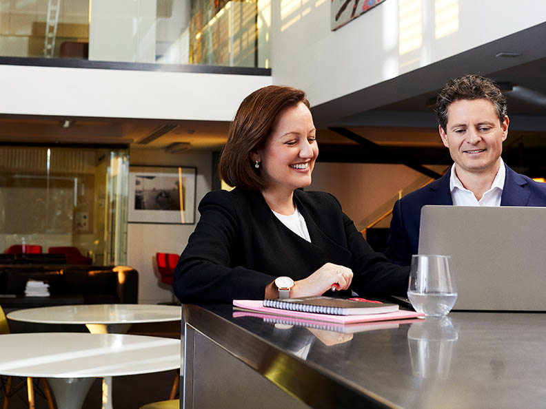 Two business professionals sitting with laptop