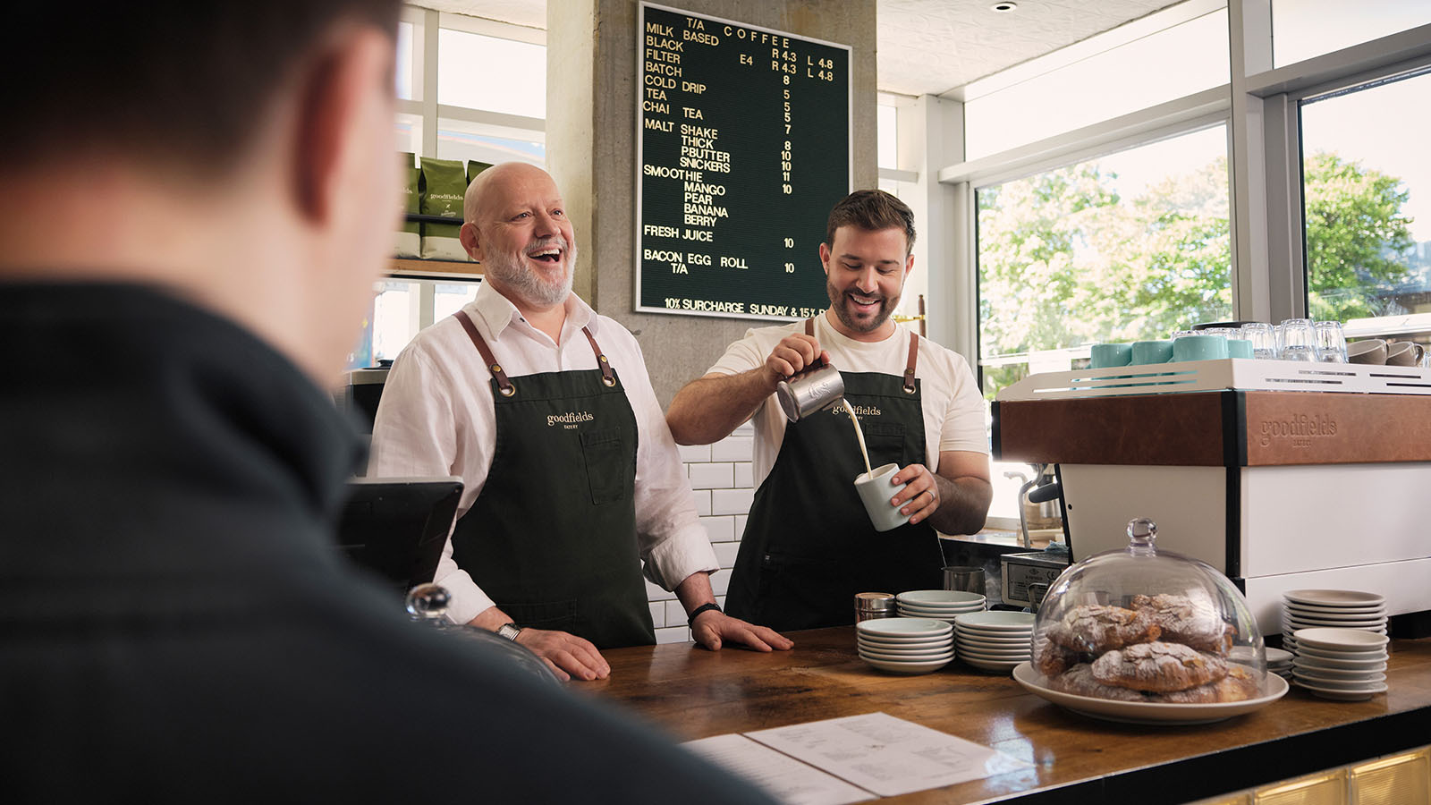 Two cafe workers smiling