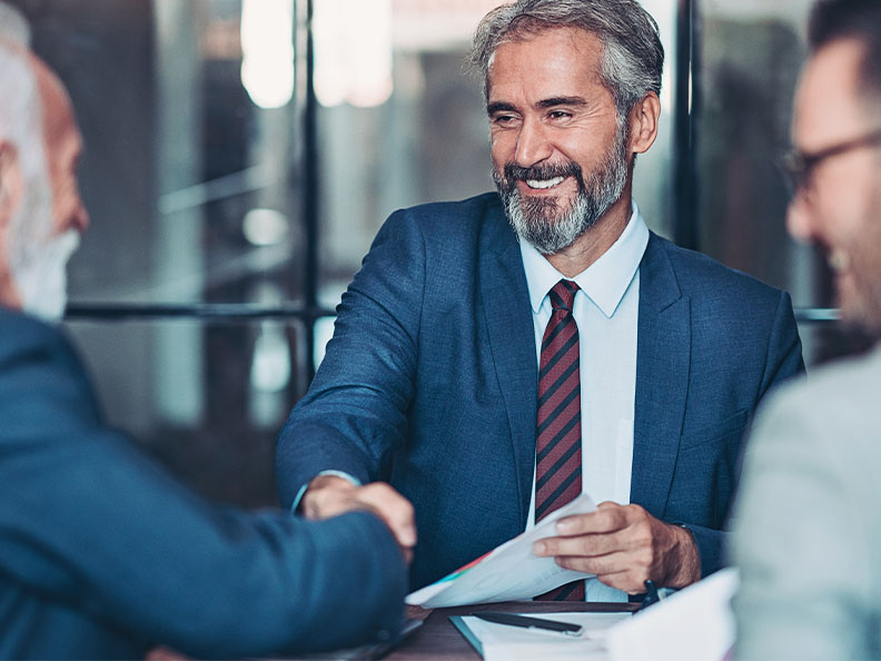 Mature businessmen shake hands with his clients