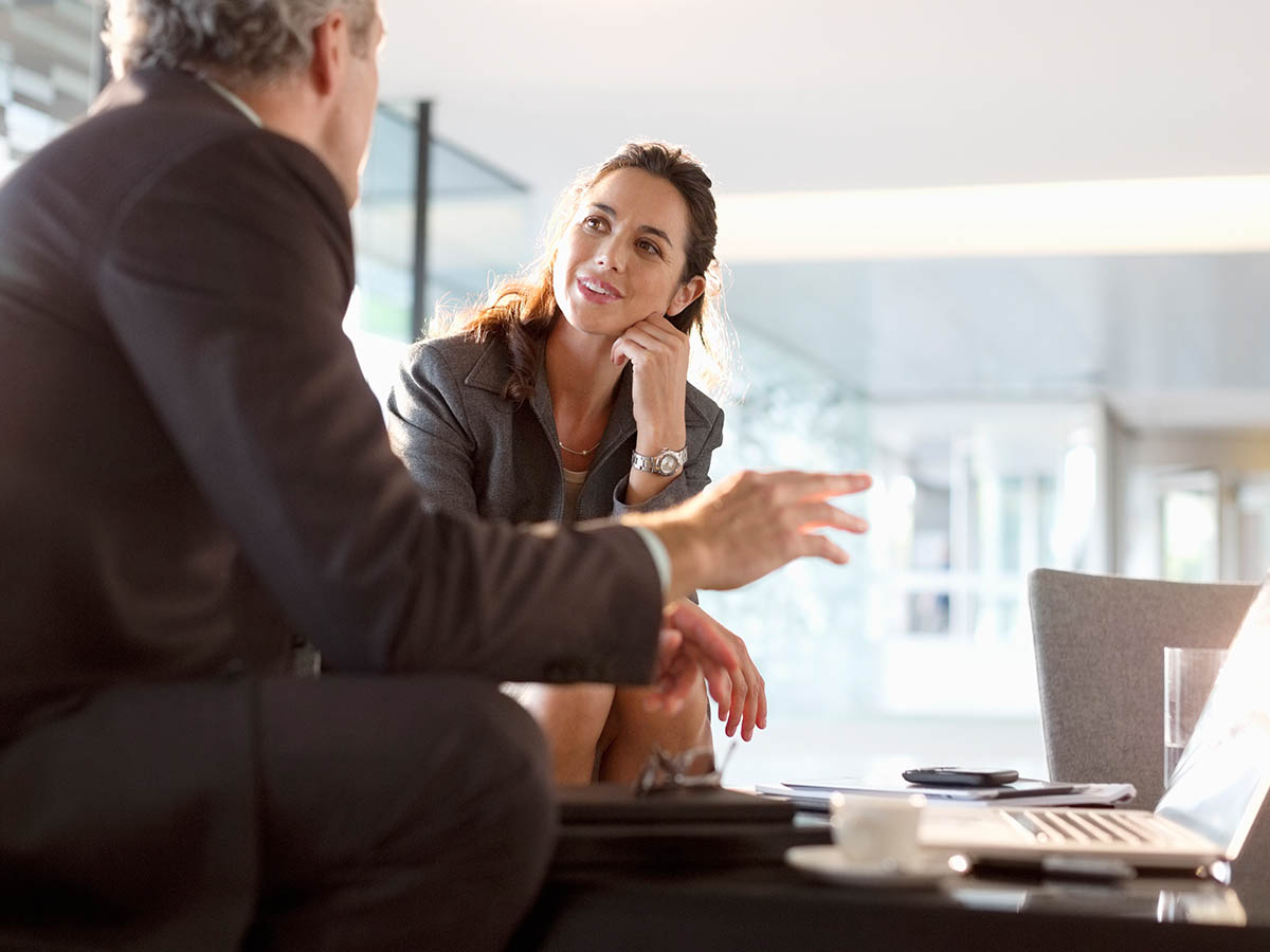 Businessman and businesswoman talking in lobby