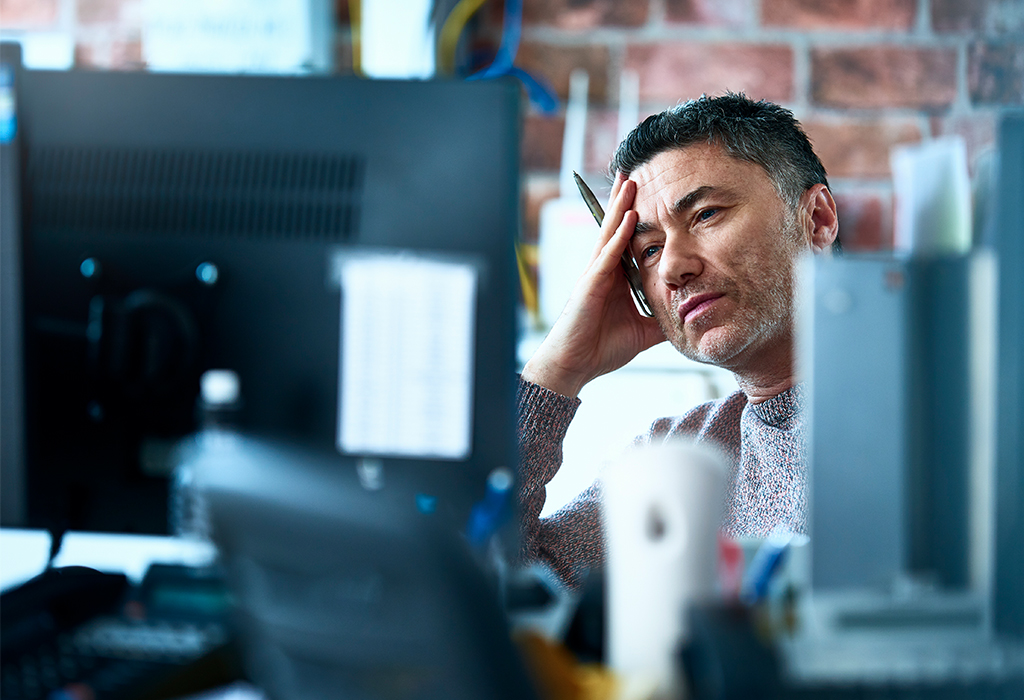 Concerned man looking at monitor