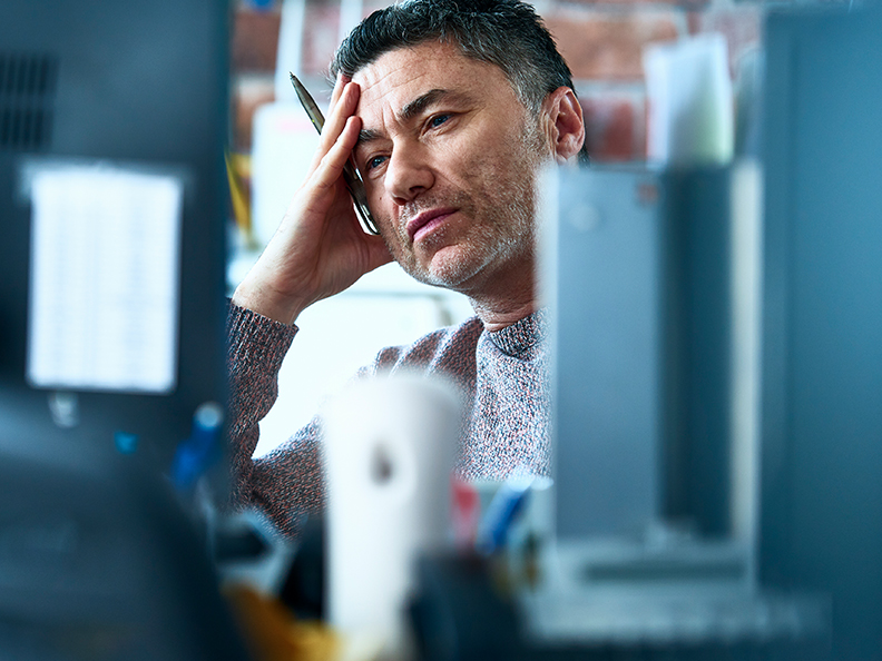 Concerned man looking at monitor