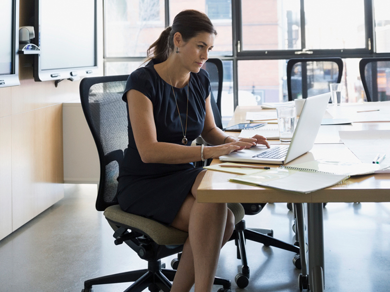 Businesswoman working at laptop in conference room