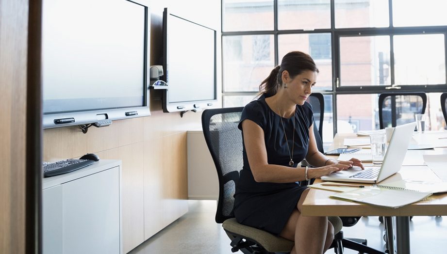 Businesswoman working at laptop in conference room