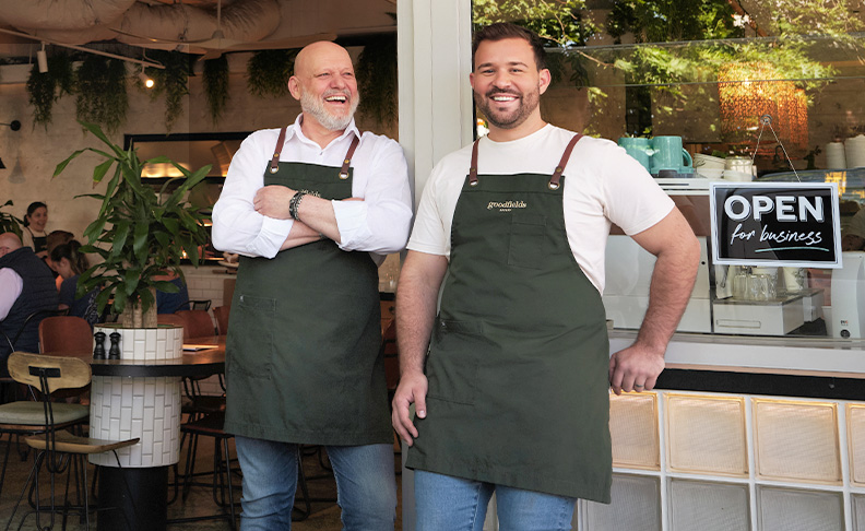 two men standing outside bakery