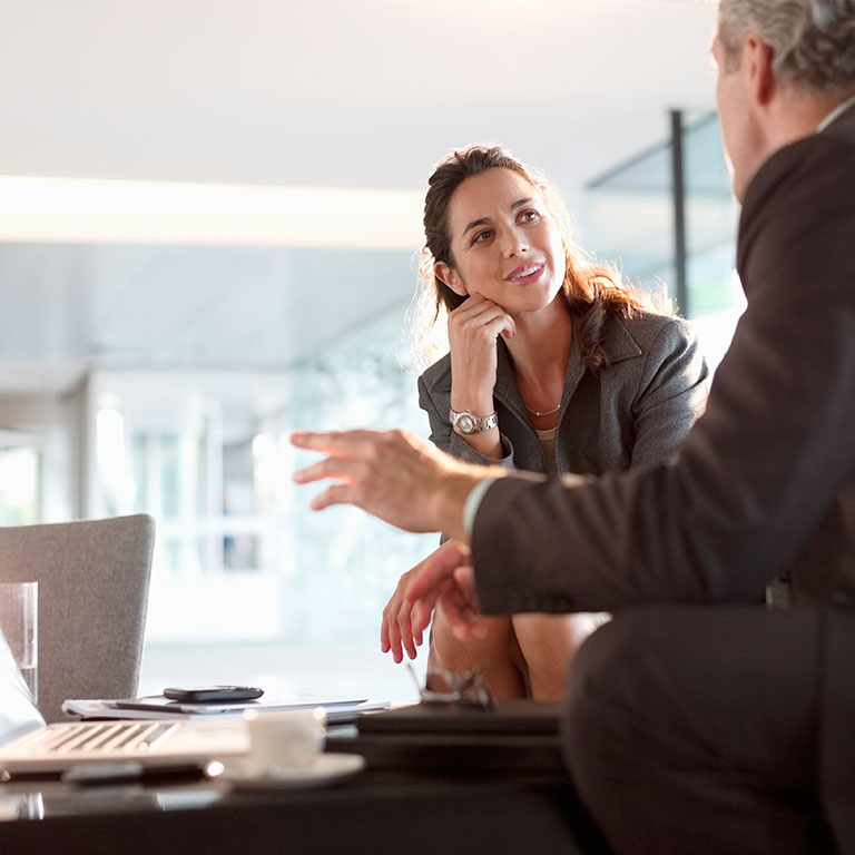 Businessman and businesswoman talking in lobby