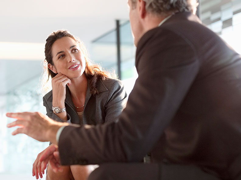 Businessman and businesswoman talking in lobby