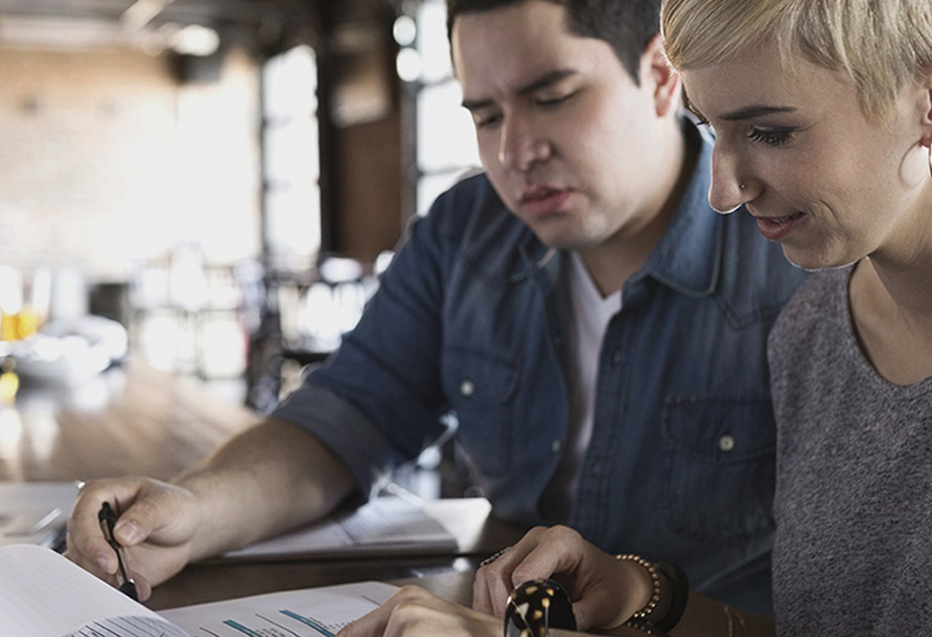 Two colleagues work together in office environment