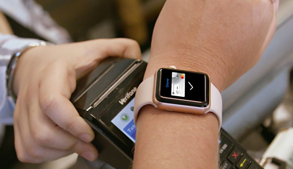 Personal paying at a payment terminal using their Apple watch.