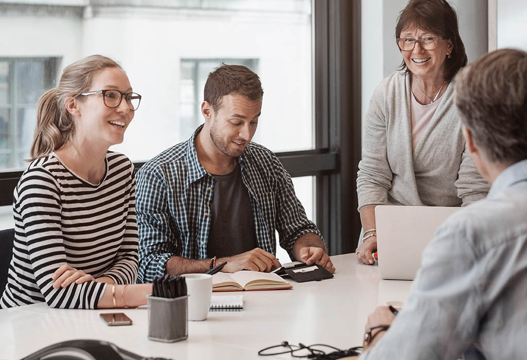 Team of four talking in meeting room