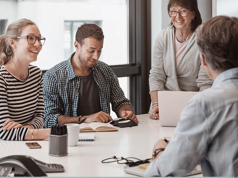 Team of four talking in meeting room