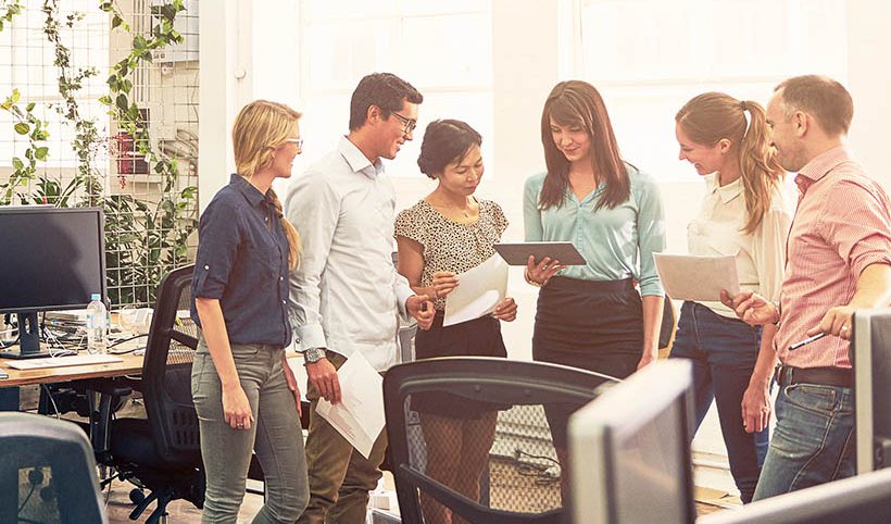 Shot of a group of coworkers talking together in an office