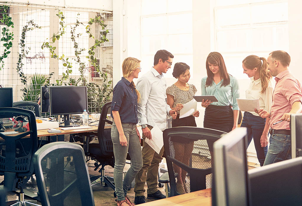 Shot of a group of coworkers talking together in an office