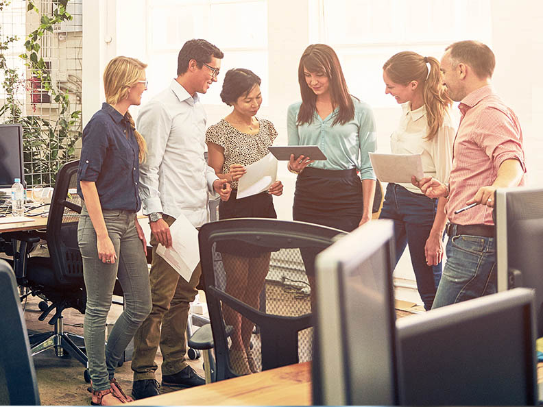 Shot of a group of coworkers talking together in an office