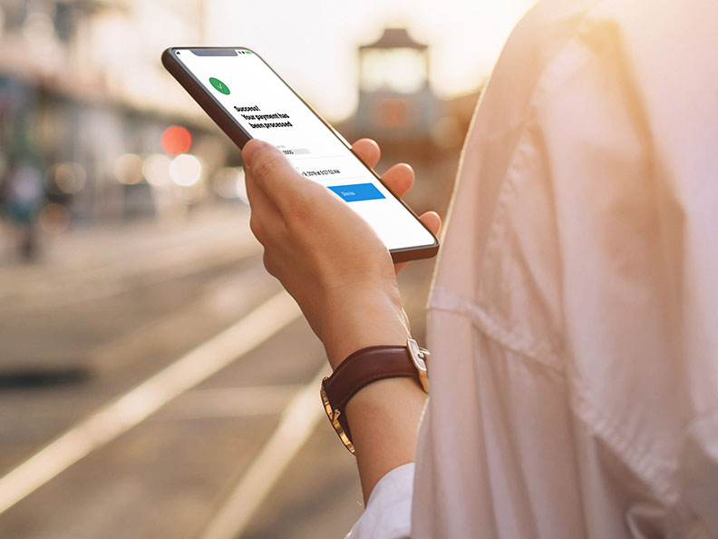 Hand holding a phone outside with the Macquarie authenticator app open