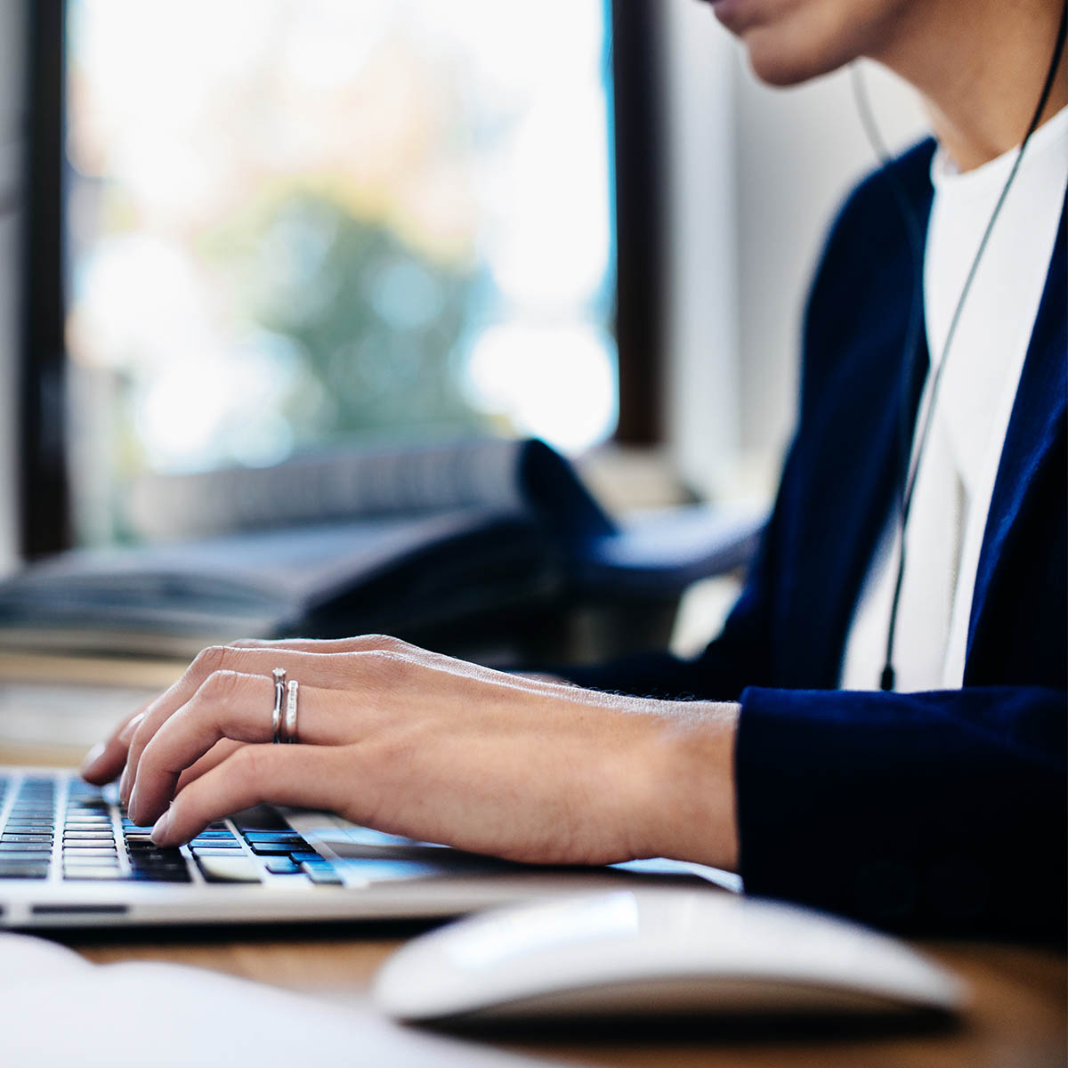 Hands typing on laptop