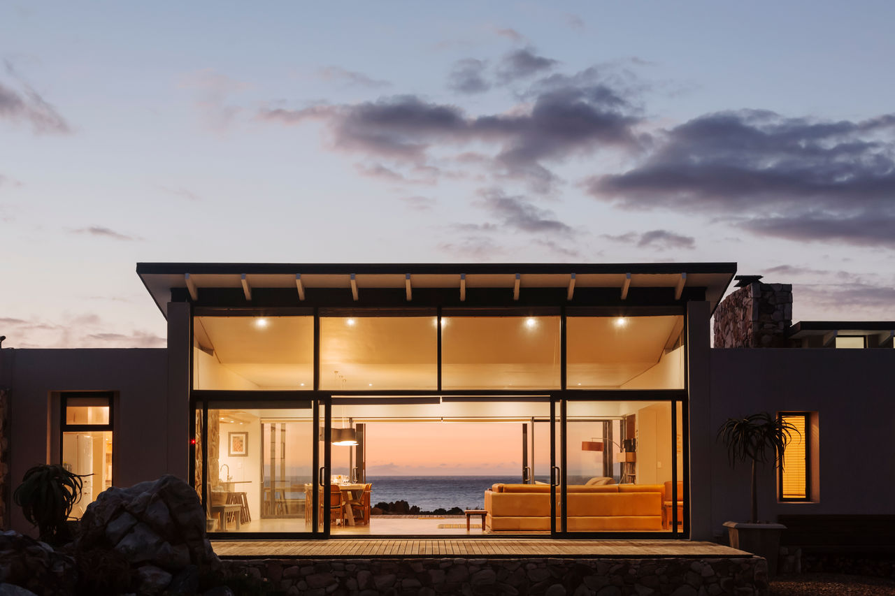 Illuminated luxury home under sky at dusk