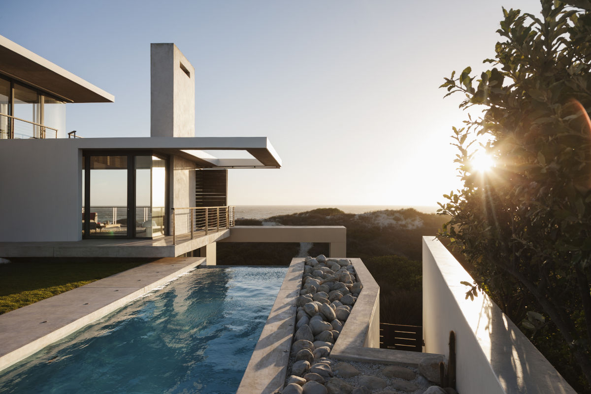 Modern luxury house overlooking beach at sunrise