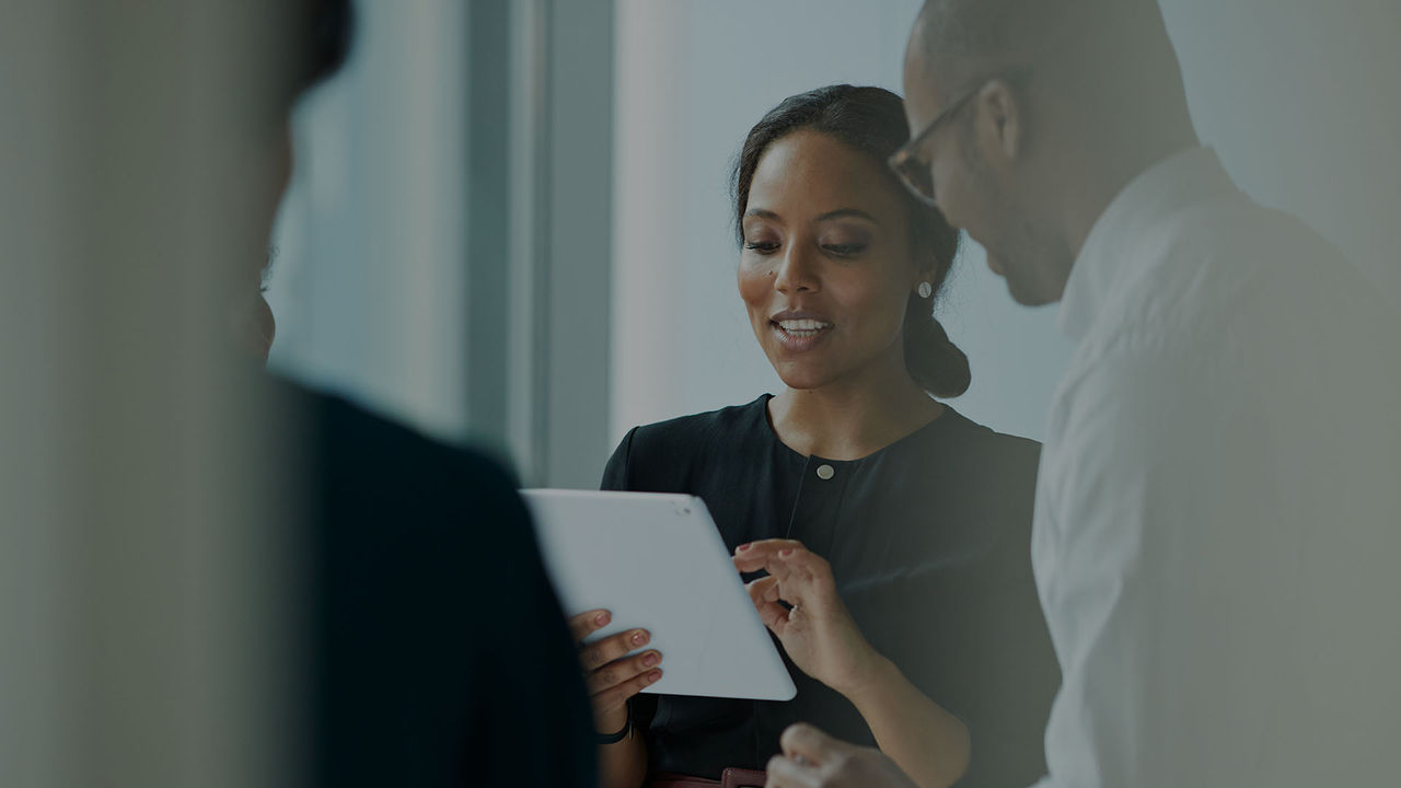 woman holding tablet in conversation