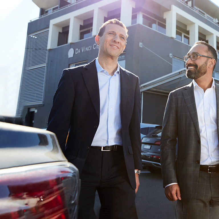 Daniel Cordaro, Director of Doceng, with business man outside property building

