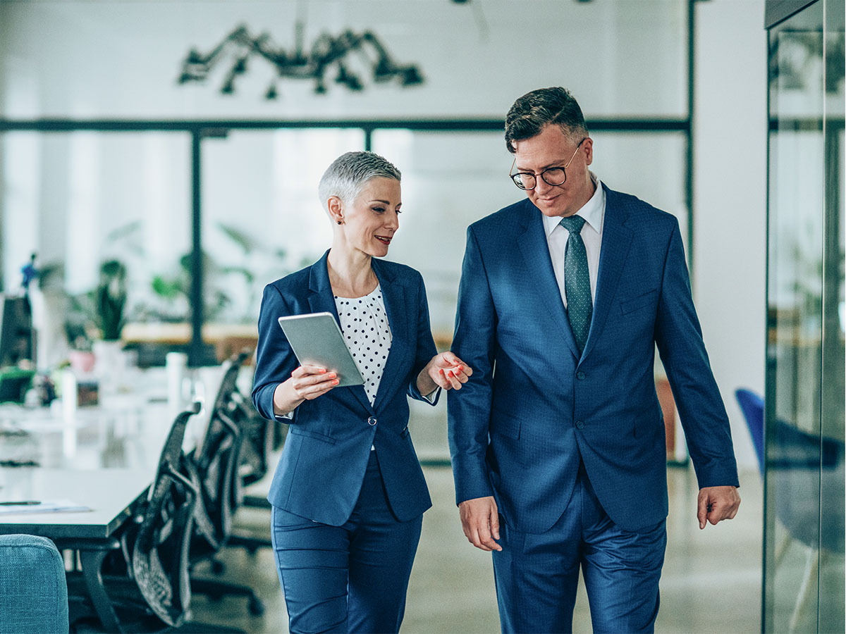 Shot of a businesswoman and businessman talking in the work place