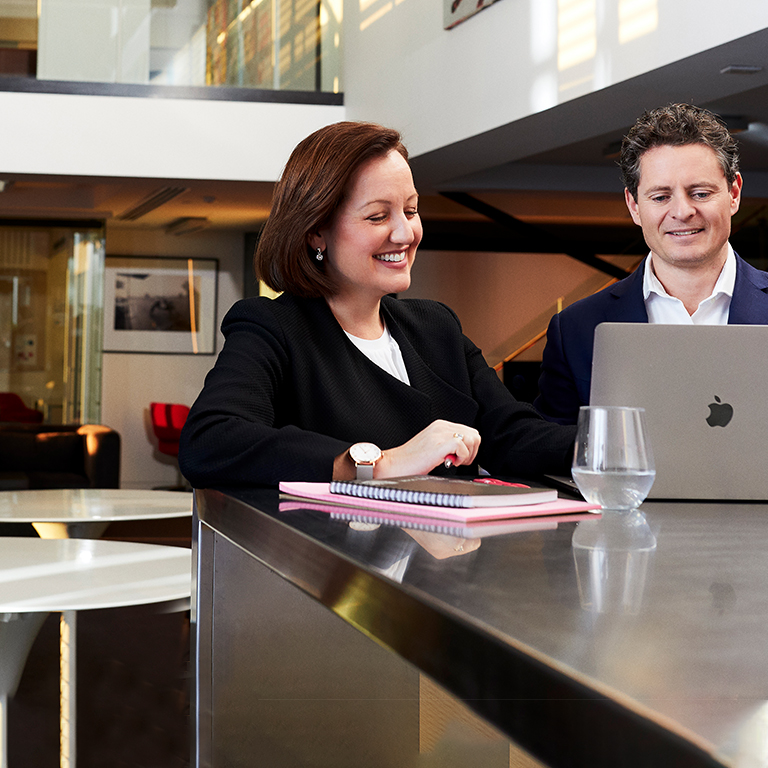 Mirus co-founder James Price with business woman on laptop