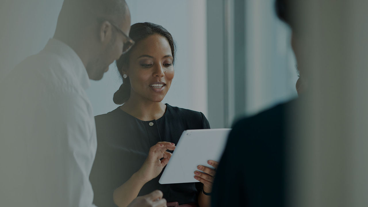 woman holding tablet in conversation