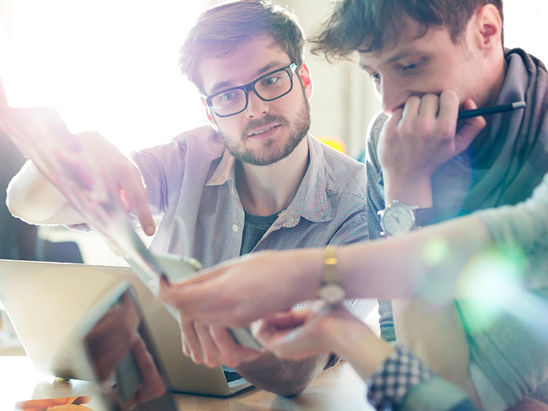 Young coworkers working on project in start-up