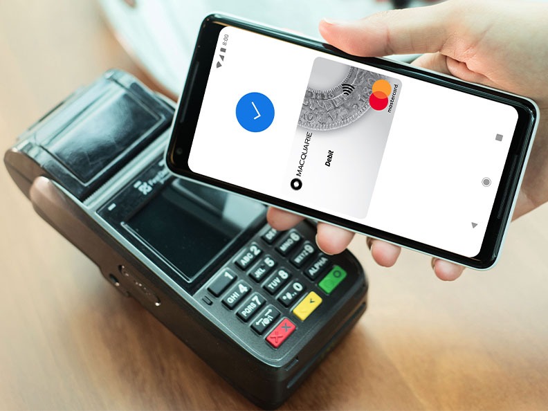 A phone showing a successful Macquarie Google Pay over a Eftpos terminal