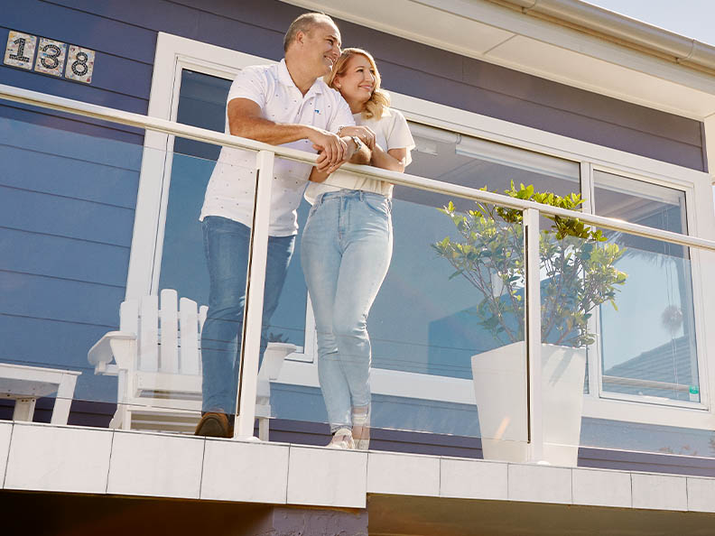 Mel and Jonathan standing on their veranda