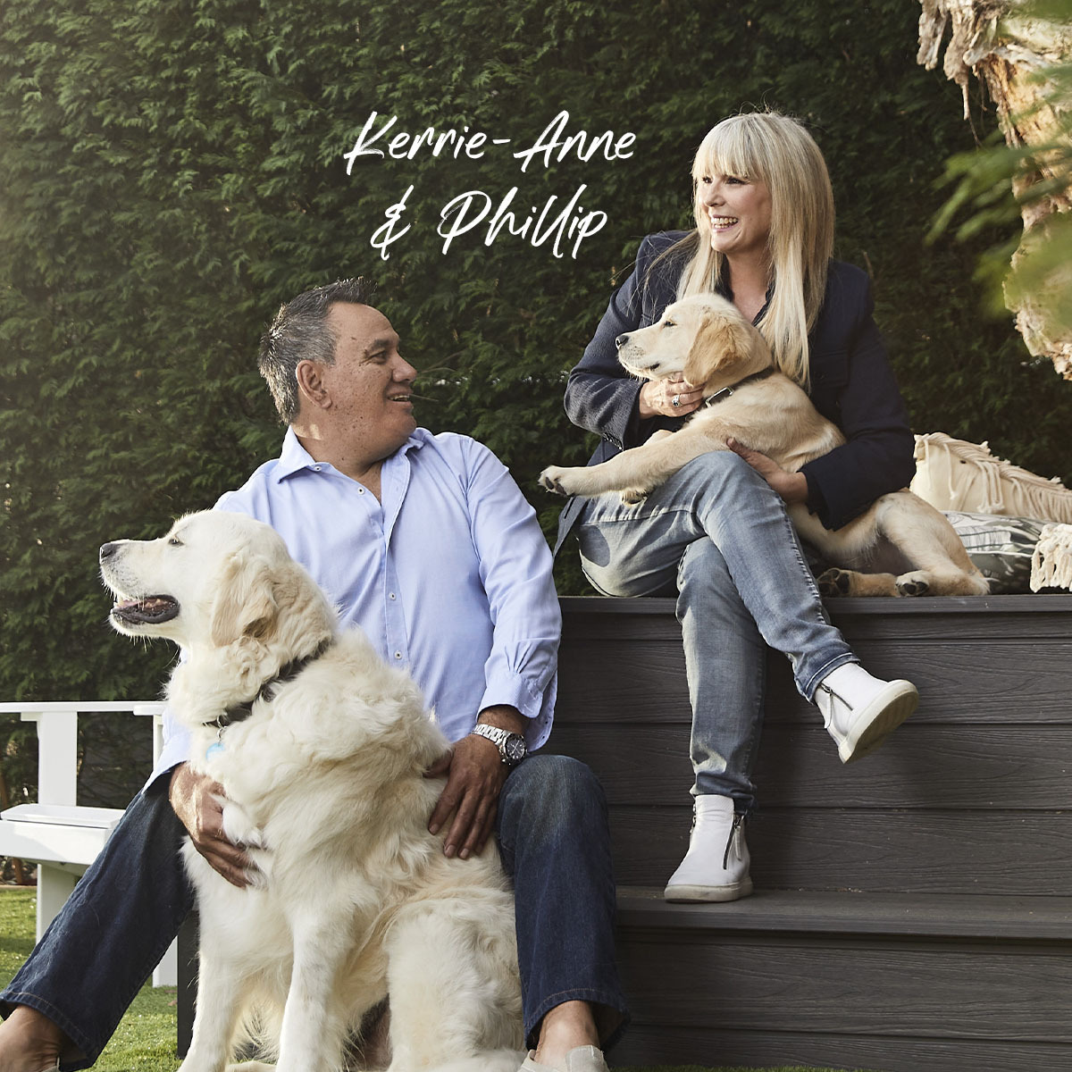 Professional couple sit in garden with their dog