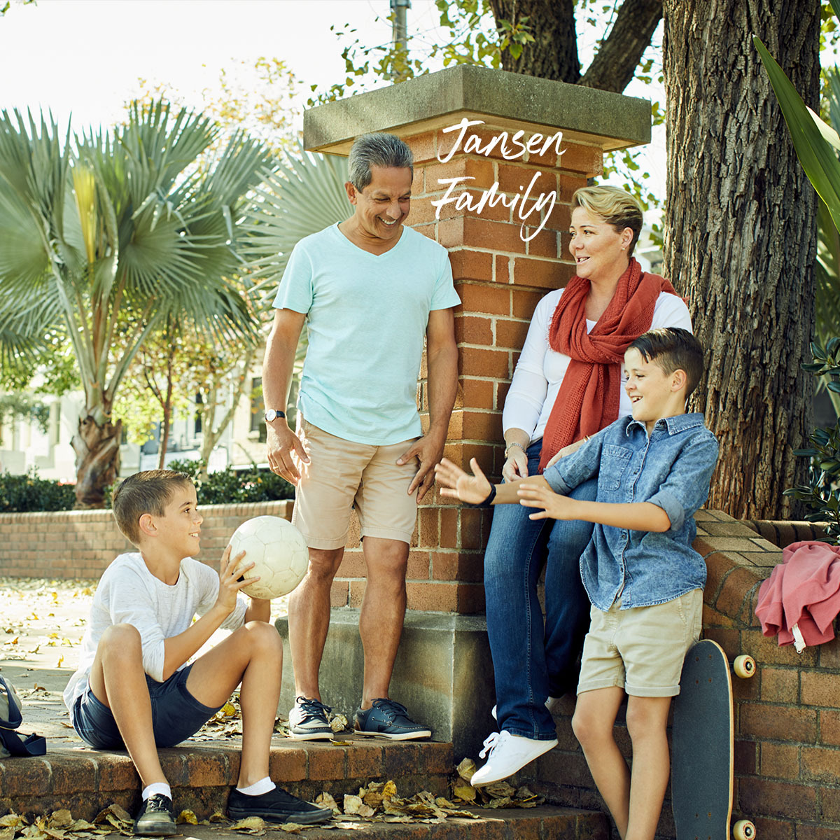 Jansen family home loan customer with kids outside in park playing and talking