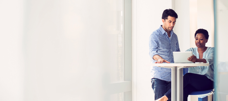 Image of a man and a woman looking at a laptop.